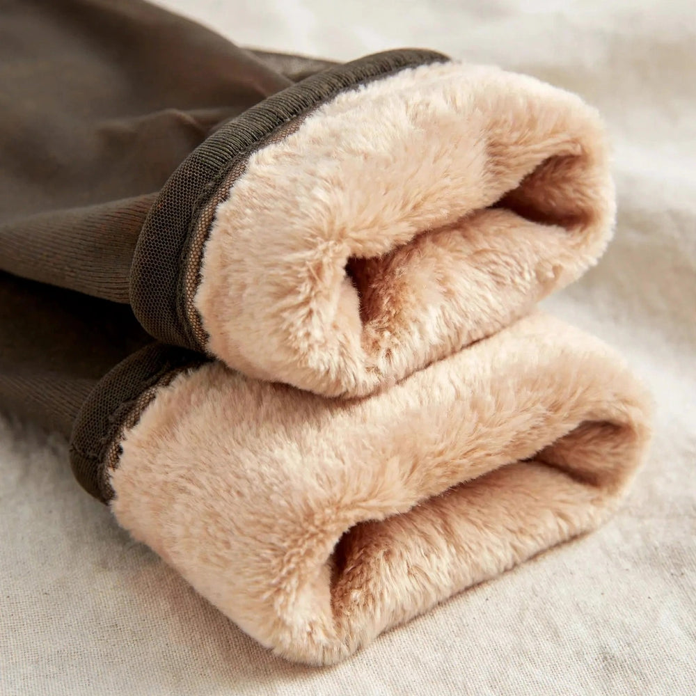 Macro view of the warm beige plush fleece lining of the tights.